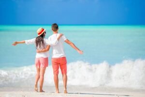 Young,Couple,On,White,Beach,During,Summer,Vacation.,Happy,Lovers