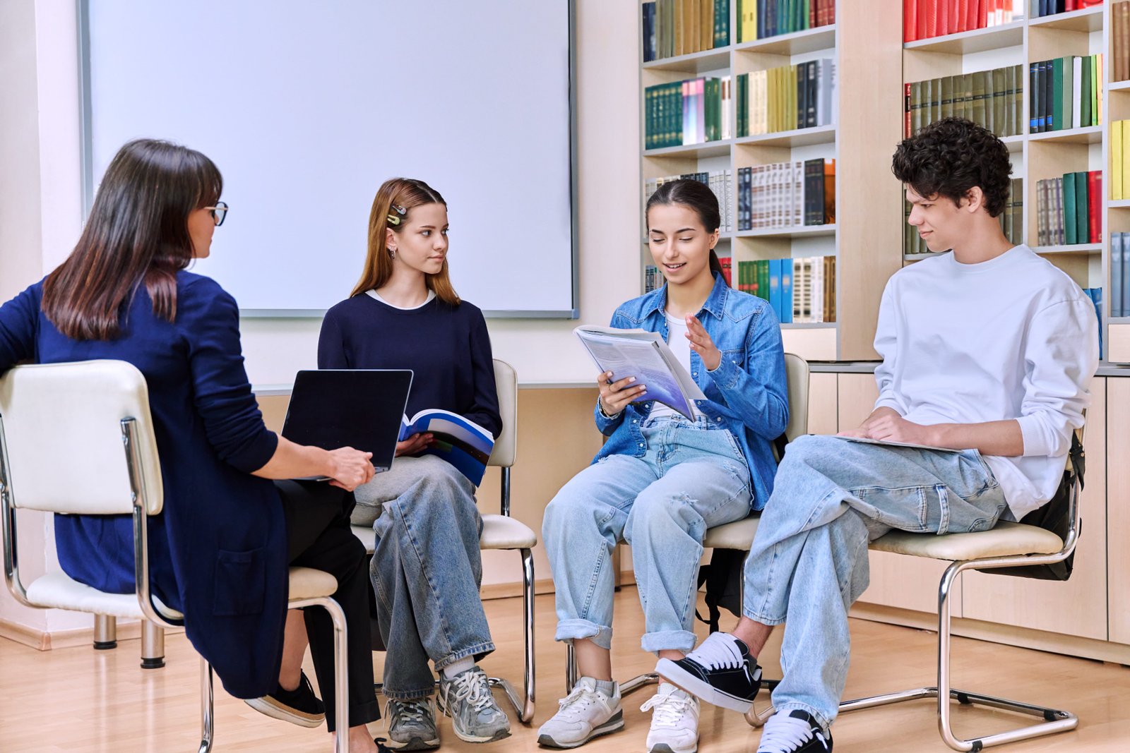 Group of Teenage Students Sitting with Female Student Education Coach